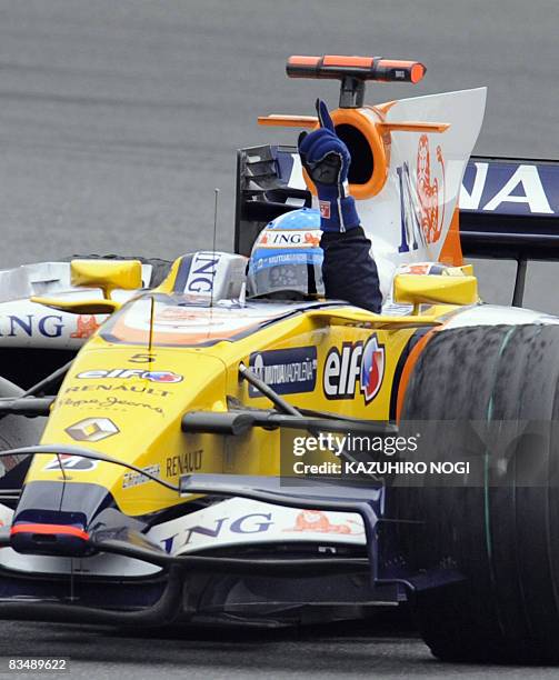 Spain's Fernando Alonso of Renault reacts after winning in the Formula One's Japanese Grand Prix at Fuji Speedway, some 100 kms west of Tokyo, on...