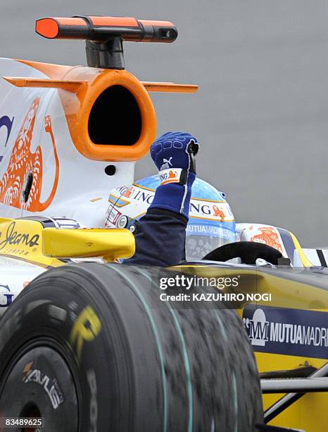 Spain's Fernando Alonso of Renault reacts after his victory in Formula One's Japanese Grand Prix at the Fuji Speedway, some 100 kms west of Tokyo, on...