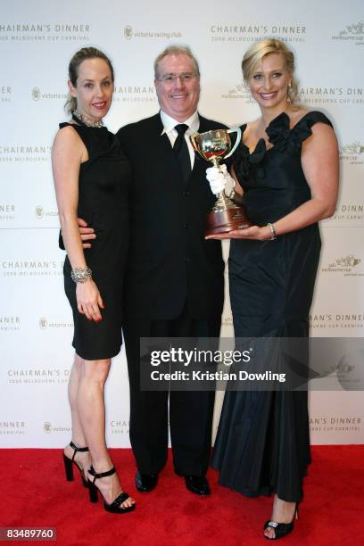 Andrew McManus and partner pose with Johanna Griggs after arriving for the Victorian Racing Clubs Chairman's Dinner in the Atrium at Flemington...