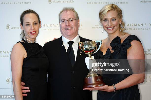 Andrew McManus and partner pose with Johanna Griggs after arriving for the Victorian Racing Clubs Chairman's Dinner in the Atrium at Flemington...