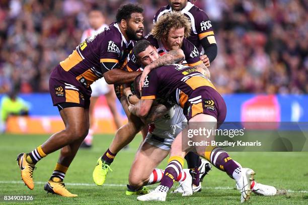 Joel Thompson of the Dragons is tackled during the round 24 NRL match between the Brisbane Broncos and the St George Illawarra Dragons at Suncorp...