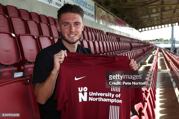 Northampton Town new signing Matt Grimes poses with a shirt during a photo call at Sixfields on August 18, 2017 in Northampton, England.