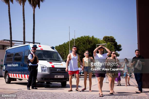 Police officer patrols on the spot where five terrorists were shot by police on August 18, 2017 in Cambrils, Spain. Fourteen people were killed and...
