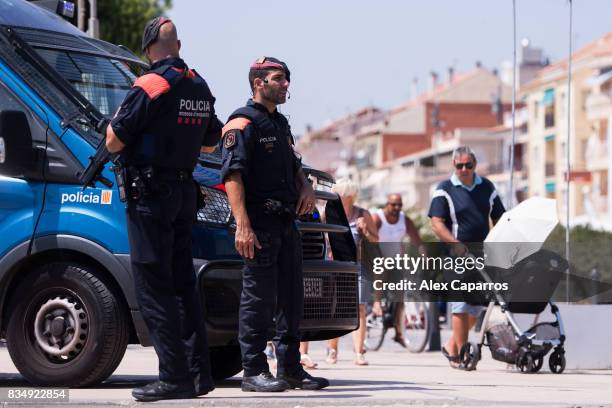 Police officers patrol on the spot where five terrorists were shot by police on August 18, 2017 in Cambrils, Spain. Fourteen people were killed and...