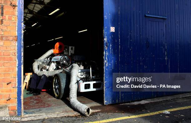 Mechanic works under a Morgan Aero 8 car
