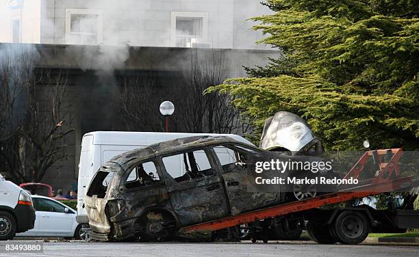 Burnt out car is removed from the scene of a car bomb on October 30, 2008 at the University of Navarra in Pamplona, Spain. At least 15 people were...