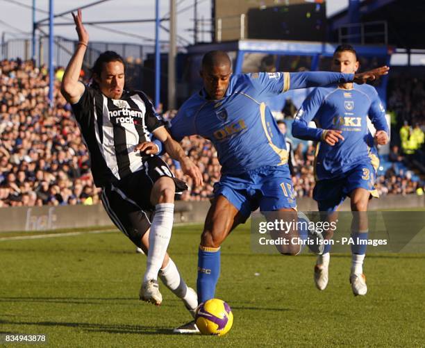 Newcastle United's Jonas Gutierrez and Portsmouth's Sylvain Distin battle for the ball.