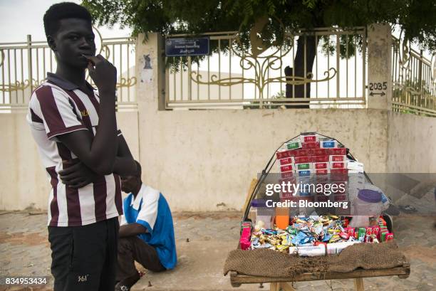 Cigarette vendor waits for customers on a roadside in N'Djamena, Chad, on Wednesday, Aug. 16, 2017. African Development Bank and nations signed...