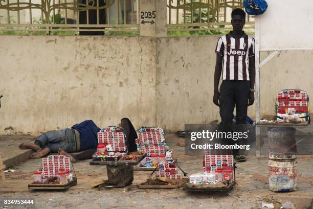 Cigarette vendor waits for customers on a roadside in N'Djamena, Chad, on Wednesday, Aug. 16, 2017. African Development Bank and nations signed...