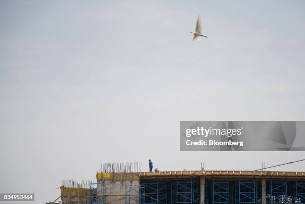 Laborers work on the upper floor of the Cit des Affaires de N'Djamena construction site in N'Djamena, Chad, on Wednesday, Aug. 16, 2017. African...