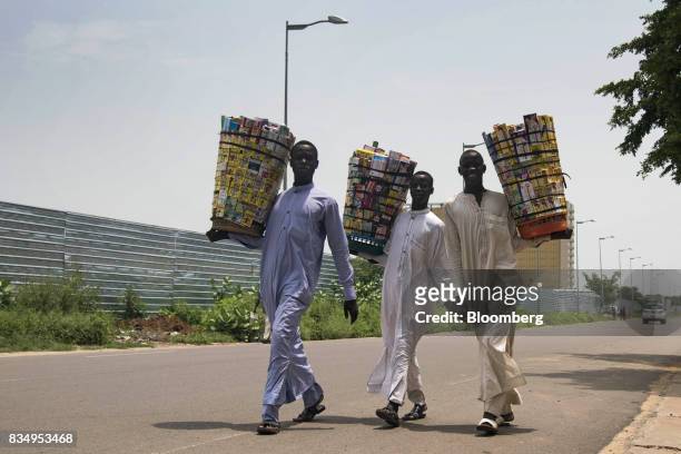 Street vendors carry baskets of medicines for sale in N'Djamena, Chad, on Wednesday, Aug. 16, 2017. African Development Bank and nations signed...