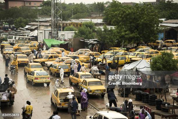 Yellow taxi cab drivers wait for customers in a parking lot in N'Djamena, Chad, on Tuesday, Aug. 15, 2017. African Development Bank and nations...