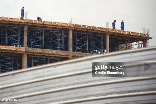 Laborers work on the upper floor of the Cit des Affaires de N'Djamena construction site in N'Djamena, Chad, on Wednesday, Aug. 16, 2017. African...