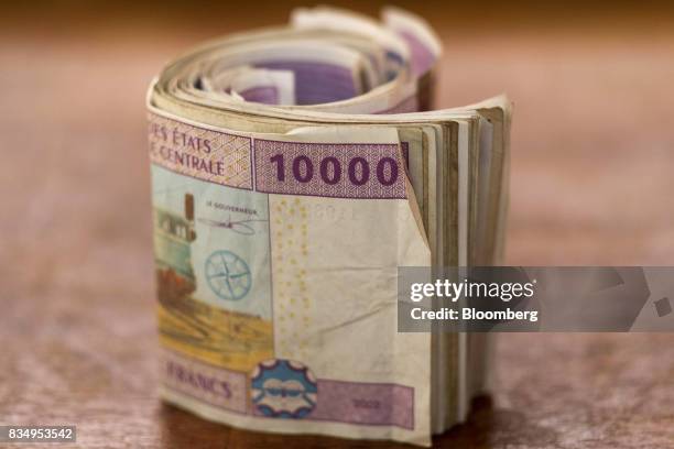 Bundle of 10,000 denomination Central African franc banknotes sit in this arranged photograph in N'Djamena, Chad, on Wednesday, Aug. 16, 2017....