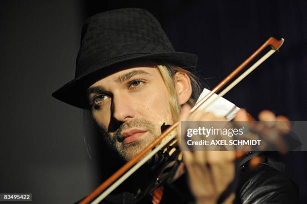 German violinist David Garrett performs during a photocall on October 30, 2008 in Berlin. He promoted his new album "Encore". AFP PHOTO DDP/AXEL...