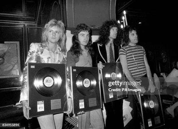 Queen rock band, Roger Taylor, John Deacon, Brian May and Freddie Mercury , with silver, gold and platinum awards they recieved from the British...