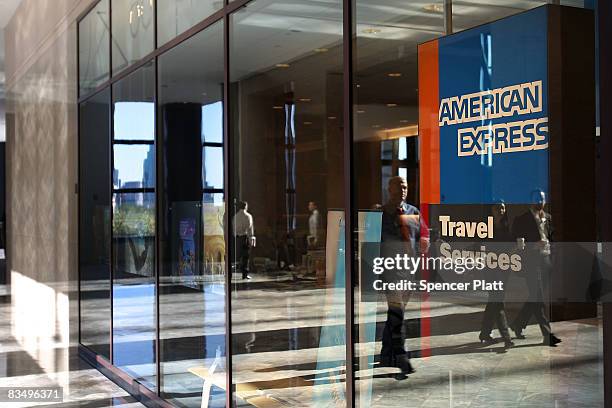 Pedestrians walk by an American Express travel agency inside the American Express headquarters October 30, 2008 in New York City. American Express, a...