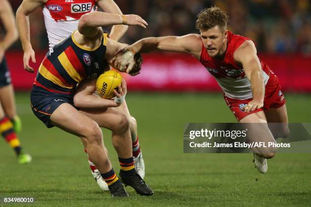 Rory Laird of the Crows is tackled by by Luke Parker of the Swans during the 2017 AFL round 22 match between the Adelaide Crows and the Sydney Swans...