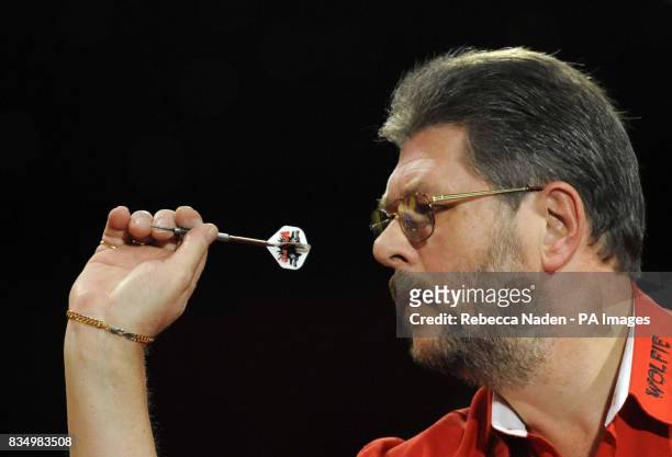 England's Martin Adams in action against Dave Chisnall during the World Darts Championship at Frimley Green, Surrey.