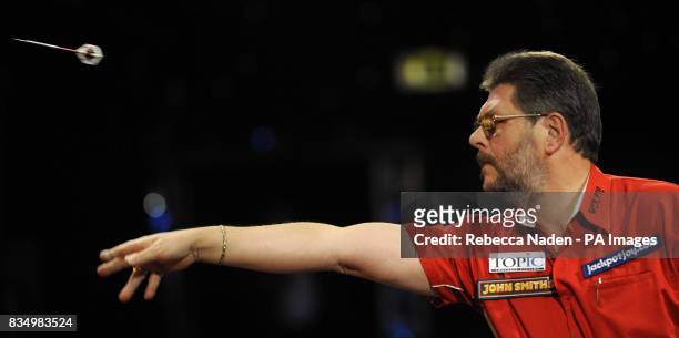 England's Martin Adams in action against Dave Chisnall during the World Darts Championship at Frimley Green, Surrey.