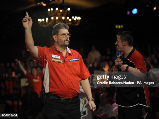 England's Martin Adams celebrates defeating Dave Chisnall during the World Darts Championship at Frimley Green, Surrey.