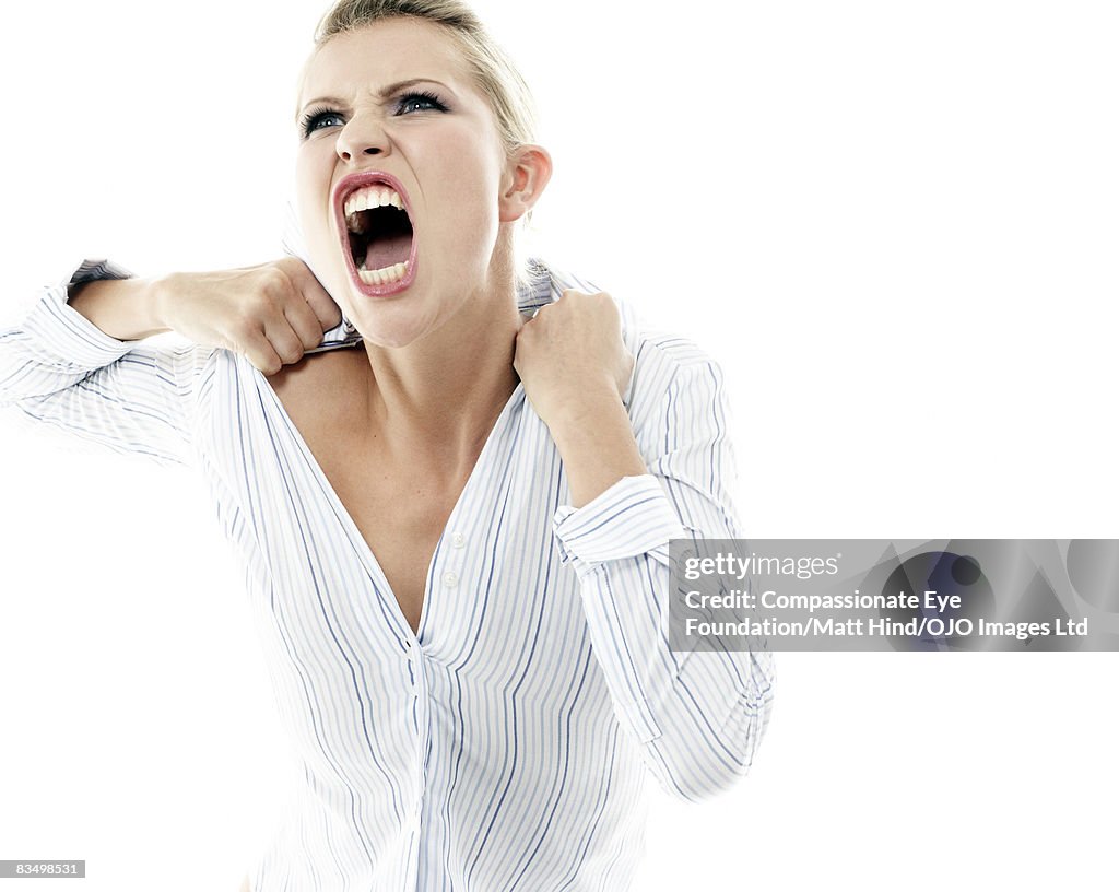 Woman screaming and pulling her shirt