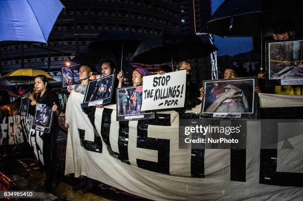 Anti-war on drugs groups hold pictures of victims of drug related extra-judicial killings on a protest in Manila, Philippines, on 18 August 2017....