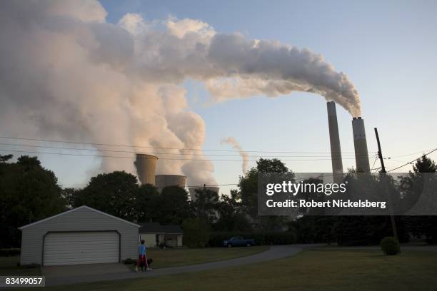 Coal smoke and steam vapor pour out of the Bruce Mansfield Power Plant overlooking a residential neighborhood at dawn on September 11, 2008 in...