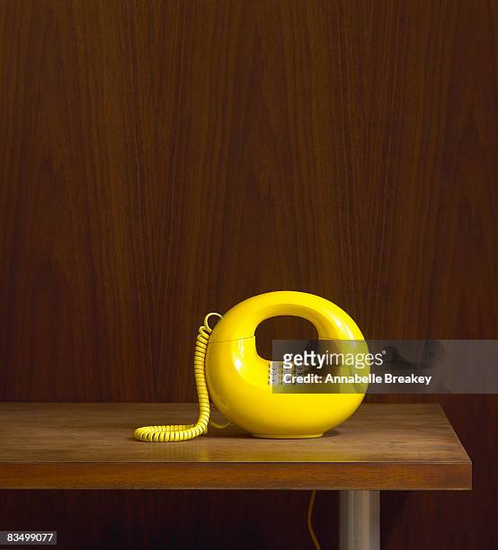 1970's vintage phone on table - vintage furniture stockfoto's en -beelden