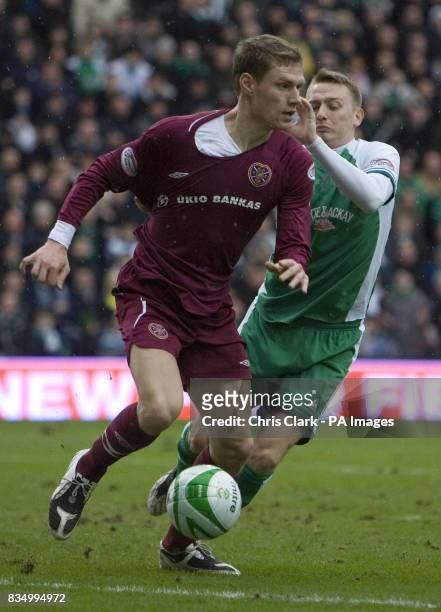 Hearts' Marius Zaliukas is tackled by Hibernian striker Derek Riordan during the Homecoming Scottish Cup match at Easter Road, Edinburgh.