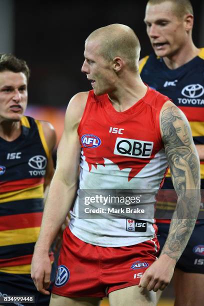 Zac Jones of the Swans gets some attention from Crows Josh Jenkins and Sam Jacobs during the round 22 AFL match between the Adelaide Crows and the...
