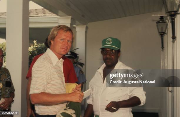 Jack Nicklaus greets a caddie at the Clubhouse during the 1978 Masters Tournament at Augusta National Golf Club in April 1978 in Augusta, Georgia.