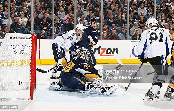 Vaclav Prospal and Steve Stamkos of the Tampa Bay Lightning watch Stamkos' shot go into the goal, his first in the NHL, past Ryan Miller and Jaroslav...