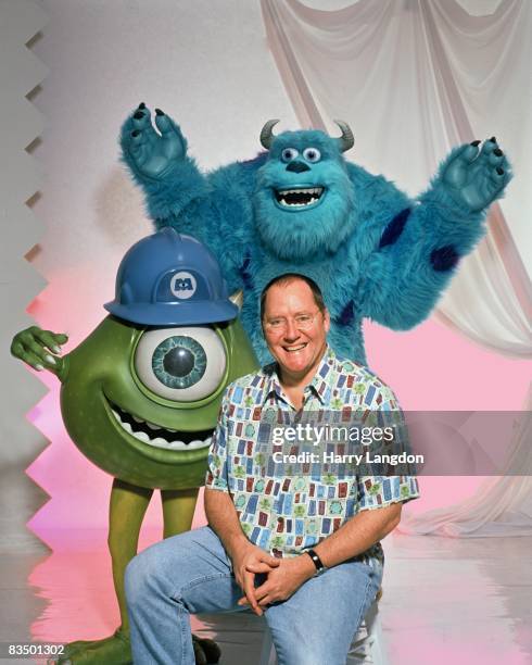 Writer, producer, director John Lasseter poses for a photo session with characters from the movie Monsters Inc on November 1, 2001 in Los Angeles,...