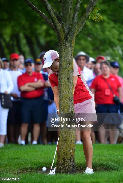 Cristie Kerr of Team USA plays a shot behind a tree on the fifth hole during the morning foursomes matches of The Solheim Cup at Des Moines Golf and...