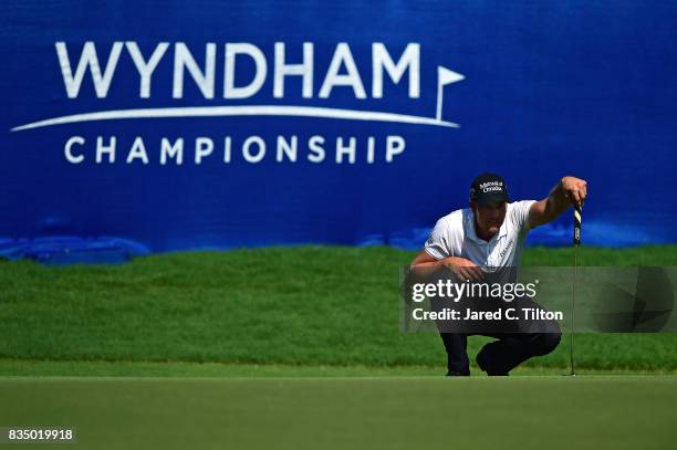 Henrik Stenson of Sweden lines up his par putt on the 18th green during the second round of the Wyndham Championship at Sedgefield Country Club on...