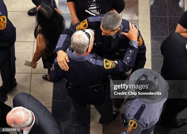 Members of the Virginia State Police and other law enforcement officers from across the country greet one another before the funeral for...