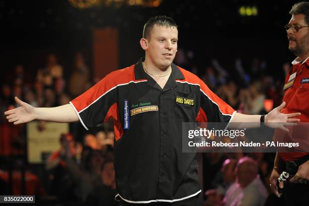 England's Dave Chisnall in action against Martin Adams during the World Darts Championship at Frimley Green, Surrey.