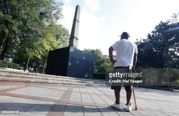 Brian Burrell pauses to look at a now covered confederate monument in Linn Park. On August 18, 2017 in Birmingham, Alabama. Alabamas attorney general...
