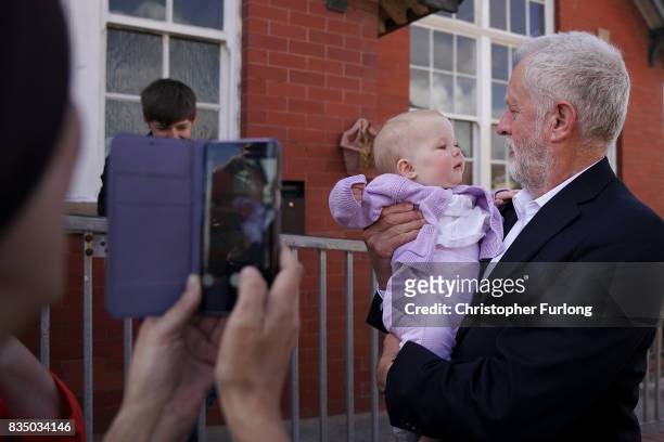 Labour Party Leader Jeremy Corbyn has his photograph taken with a baby before talks to members of Women Against State Pension Inequality Campaign...
