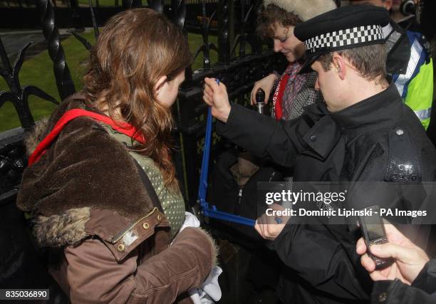 Police cut protesters free of railings outside the Houses of Parliament in Westminster, London, after a group of campaigners chained themselves to...