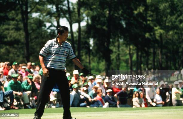 Jumbo Ozaki watches his putt in front of a large gallery during the 1990 Masters Tournament at Augusta National Golf Club in April 1990 in Augusta,...