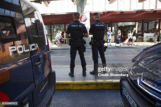 Armed police officers stand guard at the entrance to Atocha railway station in Madrid, Spain, on Friday, Aug. 18, 2017. Terrorists behind the...