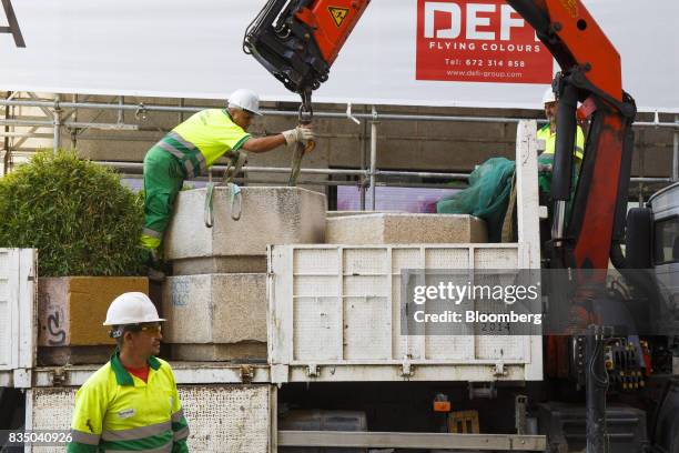 Municipal workers place street furniture on Puerta del Sol street as a security measure to prevent vehicle access in Madrid, Spain, on Friday, Aug....