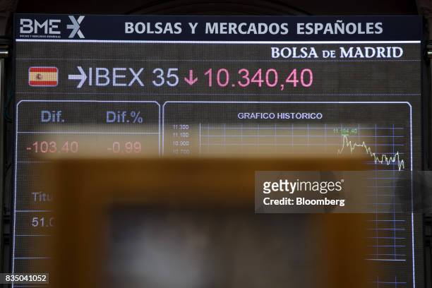 Stock price information for the IBEX 35 index sits on electronic screens inside the Madrid stock exchange, also known as Bolsas y Mercados Espanoles,...