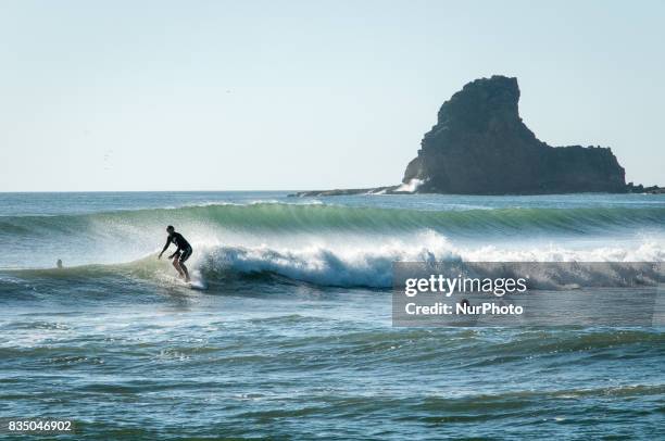 Surfer rides the waves of the Pacific Ocean near San Juan del Sur, Nicaragua, a popular surfing destination on 7 November 2011.