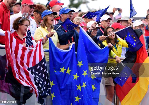Fans hold flags on the first tee during the morning foursomes matches of the Solheim Cup at the Des Moines Golf and Country Club on August 18, 2017...