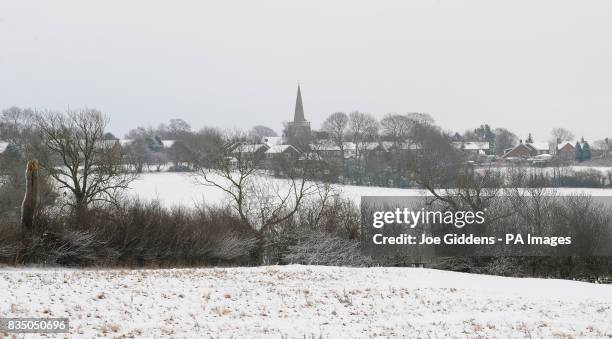 Houghton church can be seen on the horizon across snow covered fields along Uppingham Road between Bushby and Houghton on the Hill, Leicestershire.