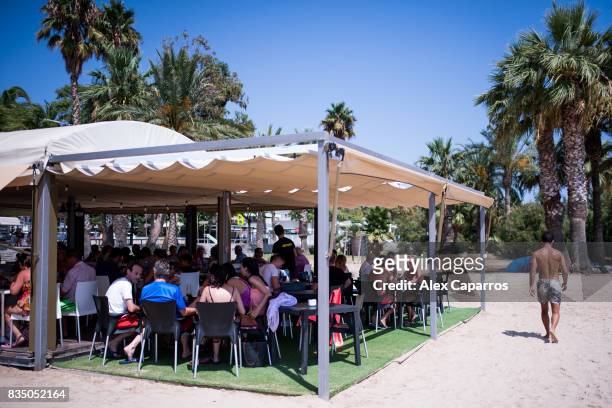 Tourists have lunch in a restaurant in the beach next to the spot where five terrorists were shot by police on August 18, 2017 in Cambrils, Spain....