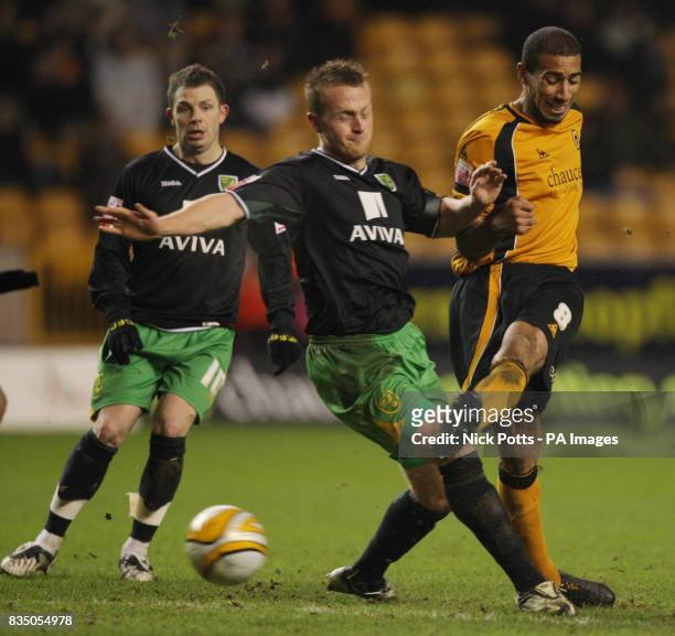 Wolverhampton Wanderers' Karl Henry, right, shoots for goal as he's challenged by Norwich City's Sammy Clingan during the Coca-Cola Championship...